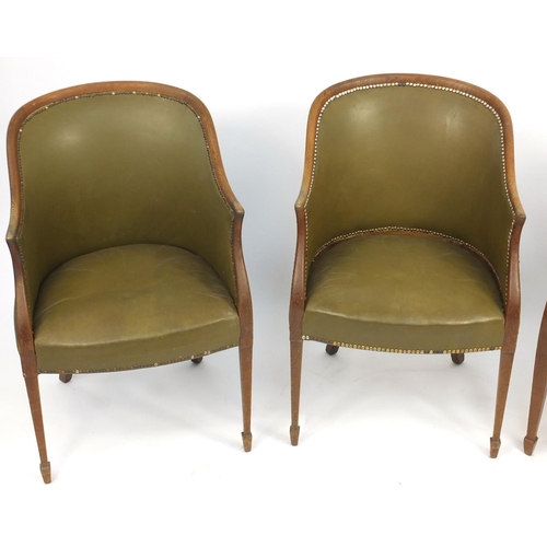 99 - Three Edwardian oak framed tub chairs, with green leatherette upholstery raised on tapering legs, 87... 