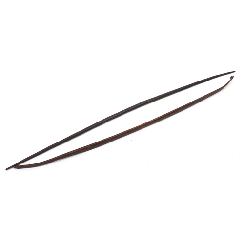 165 - Two tribal long bows, the largest 160cm in length