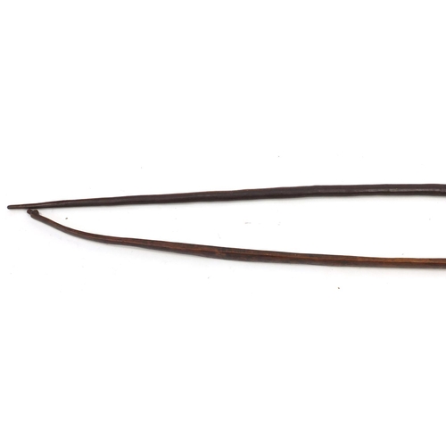165 - Two tribal long bows, the largest 160cm in length