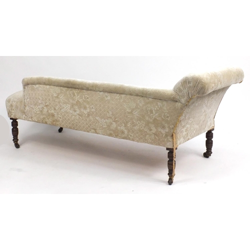 15 - Victorian walnut chaise lounge with carved decoration cream floral upholstery, 160cm in length