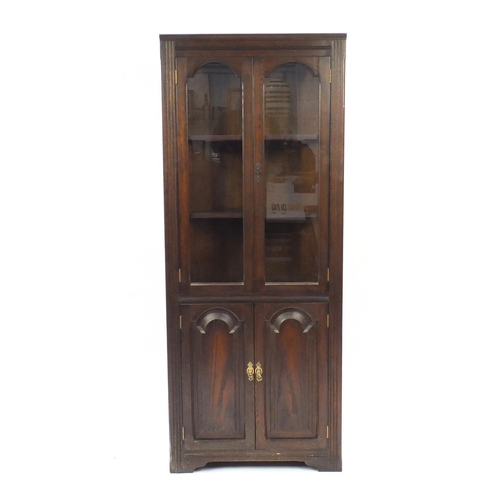 61 - Oak corner cabinet fitted with a pair of glazed doors above a pair of cupboard doors, 178cm H x 72cm... 