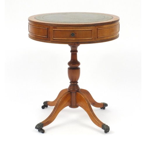 16 - Yew drum table with tooled leather insert and brass paw feet, 58.5cm high x 48.5cm in diameter