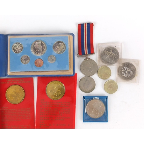 665 - British and World coins including five pound and two pound coins and a British Military World War II... 