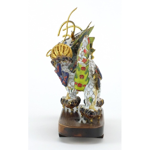 230 - Chinese gilt metal and enamel dragon raised on hardwood stand, 22.5cm in length