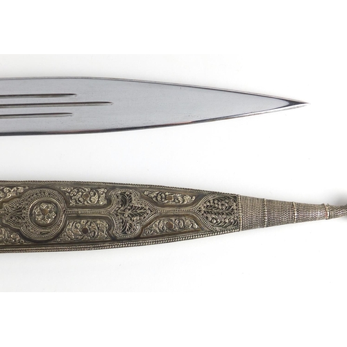 426 - Caucasian Kindjal dagger with silver coloured metal handle and scabbard, each having foliate motifs ... 