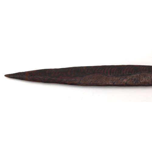 622 - Australian Aboriginal Churinga carved with tribal motifs, 58cm in length