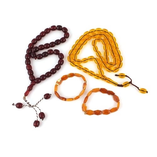 313 - Two amber coloured bead necklaces and two bracelets, the largest 76cm in length, approximate weight ... 