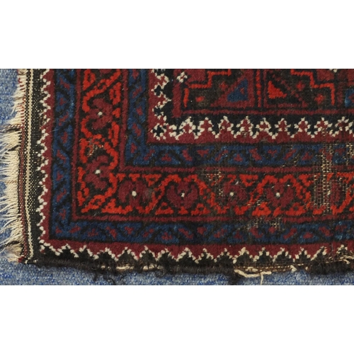 130 - Rectangular Afghan Baluch rug having an all over stylised floral design within corresponding borders... 