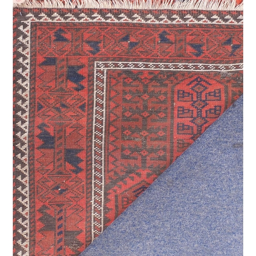 117 - Rectangular Persian Baluch red ground rug, 162cm x 93cm
