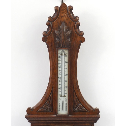 62 - Oak aneroid barometer carved with a shield, 90cm high