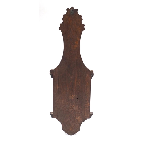62 - Oak aneroid barometer carved with a shield, 90cm high