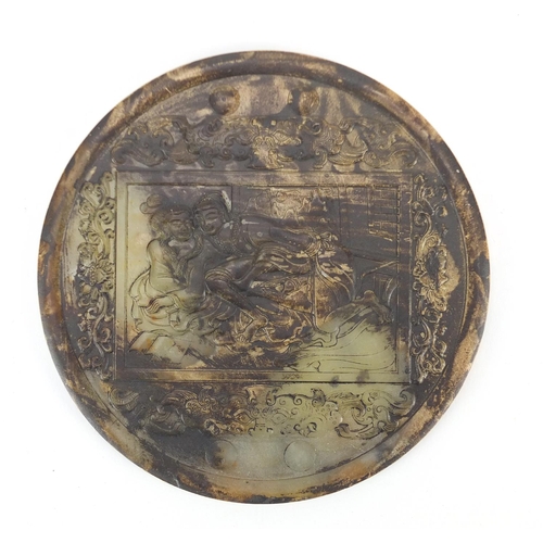 440 - Chinese circular green jade panel carved with an erotic scene, 17cm in diameter