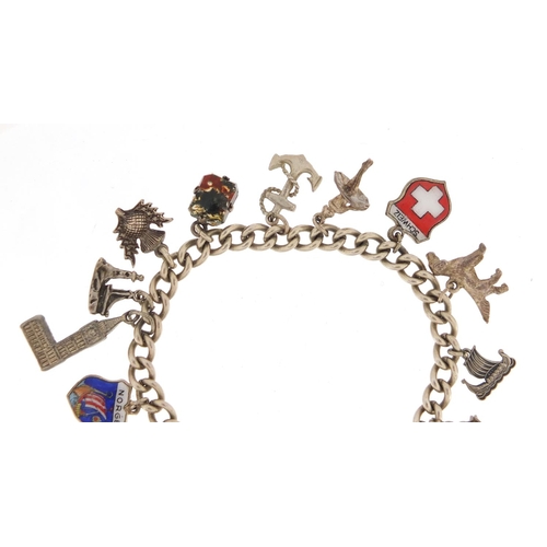 318 - Silver charm bracelet with a selection of mostly silver charms, including some enamelled, approximat... 