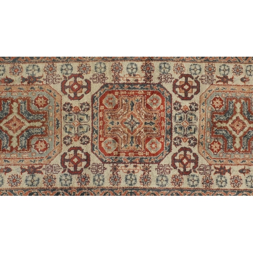 2081 - Chinese Persian design silk rug, the ivory central field having a flower head design within correspo... 