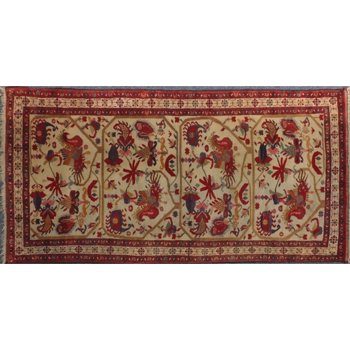 2027 - Rectangular Persian rug, the central field depicting birds of paradise and flowers onto an ivory fie... 