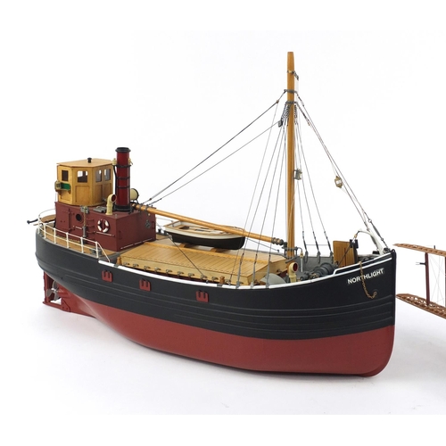 589 - Model of a fishing boat and a bi-plane, the boat 62cm in length