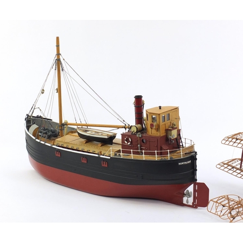 589 - Model of a fishing boat and a bi-plane, the boat 62cm in length