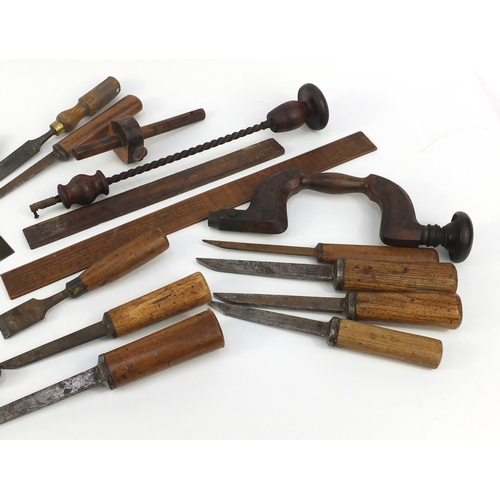 290 - Vintage wood working tools including a brace, chisels, mitre gauges and wooden rules