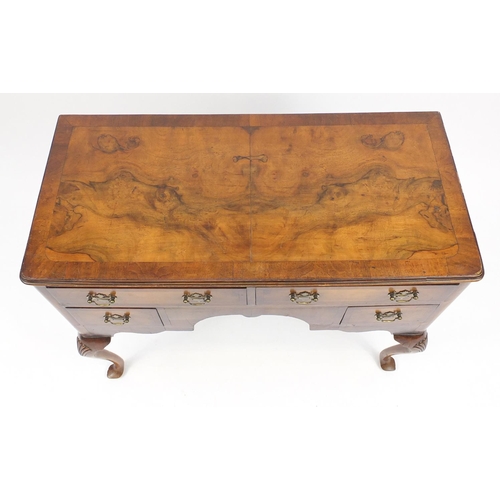 2051 - Walnut and mahogany cross banded low boy, fitted with four drawers on shell carved cabriole legs, 80... 
