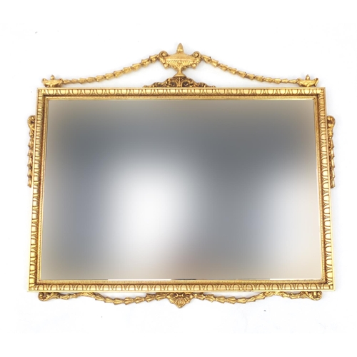 33 - Gilt framed mirror with urn and swag finial and bevelled glass, over all 86cm x 75cm