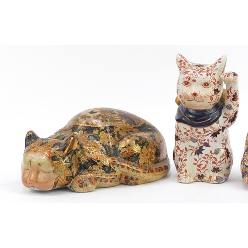 169 - Three Chinese hand painted pottery cats, the largest 32cm in length