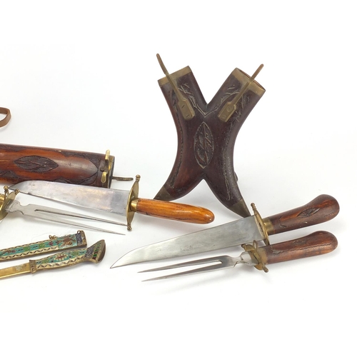 571 - Two wooden carving sets, an enamelled knife and pair of binoculars with leather case