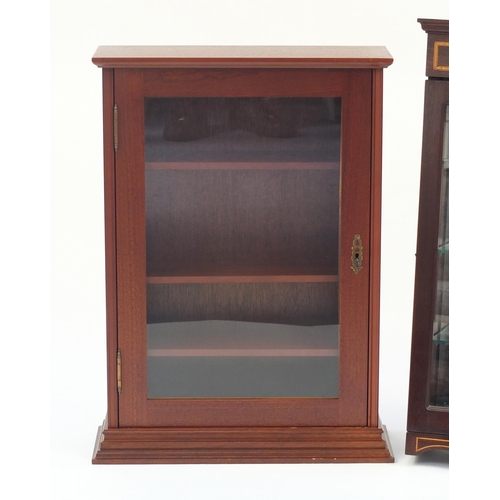 69 - Two wall hanging display cases with adjustable shelves, the largest 73cm H x 52.5cm W x 18cm D