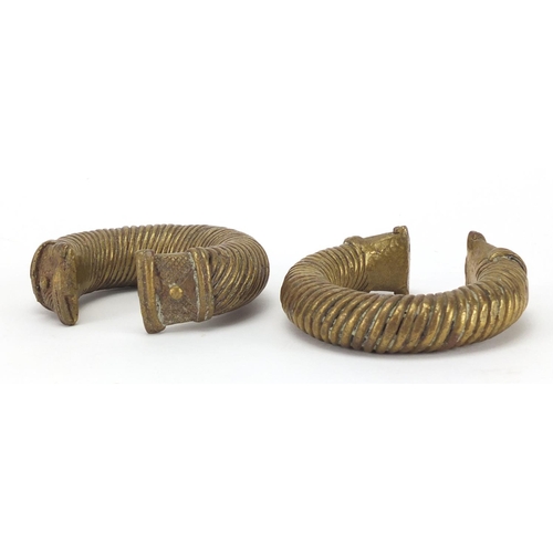 395 - Two Indian bronze bangles, 8cm in diameter