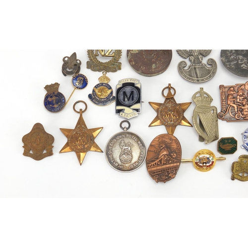 670 - Vintage and later Militaria and badges including two British Military stars, a Queen's Own Royal Wes... 