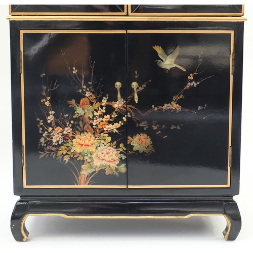 2004 - Chinese black lacquered display cabinet, hand painted with birds and flowers, having a pair of bevel... 