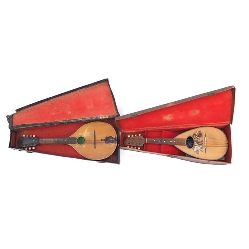 195 - Vintage melon shaped mandolin and one other eight string musical instrument, both with leather cases