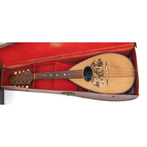 195 - Vintage melon shaped mandolin and one other eight string musical instrument, both with leather cases