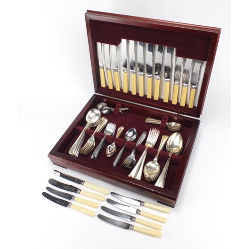 534 - Silver plated and stainless steel cutlery housed in a mahogany canteen