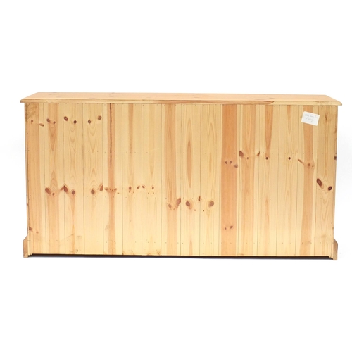 2052 - Pine seven drawer chest, 75cm H x 147cm W x 42cm D