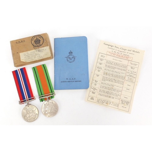 668 - Two British Military World War II medals with postage box and WAAF booklet