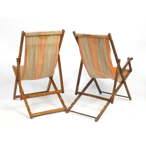 127 - Two vintage teak folding deckchairs