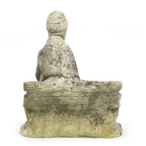 142 - Stoneware garden figure of a tramp seated on a bench, 40cm high