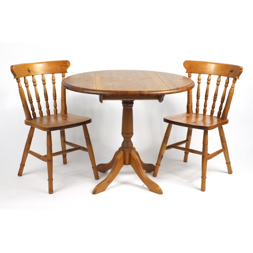 64 - Pine drop leaf dining table and two chairs