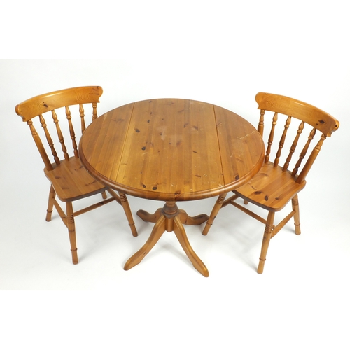 64 - Pine drop leaf dining table and two chairs