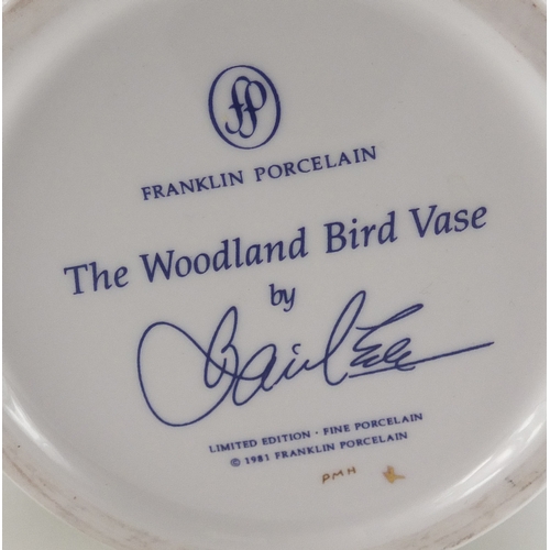 220A - Franklin porcelain woodland bird vase with hardwood stand, 31cm high