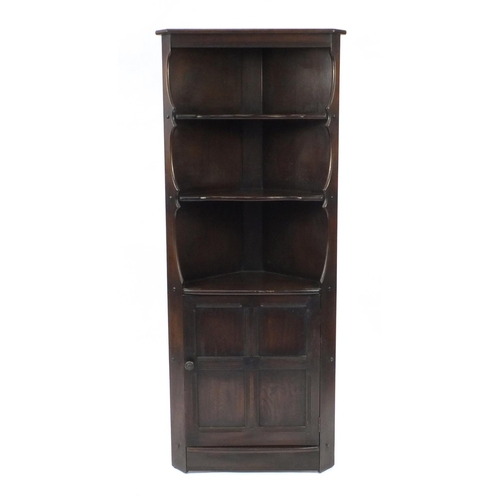 43 - Ercol dark elm corner cupboard fitted with three open shelves, above a cupboard door, 184cm H x 76cm... 