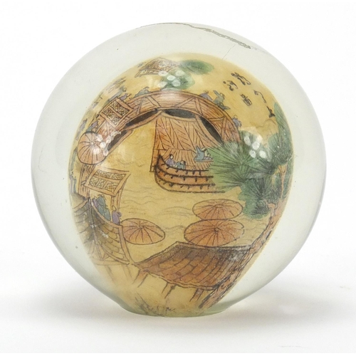 495 - Chinese glass paperweight internally hand painted with a village scene, 8cm high