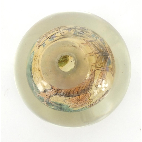 495 - Chinese glass paperweight internally hand painted with a village scene, 8cm high