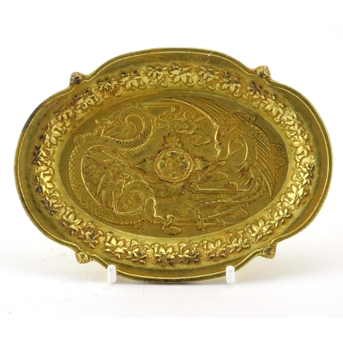 231 - Chinese gilt metal dish cast with a phoenix and dragon, 14.5cm wide