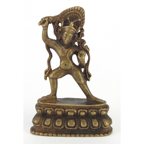 402 - Tibetan Patinated bronze figure, 7cm high
