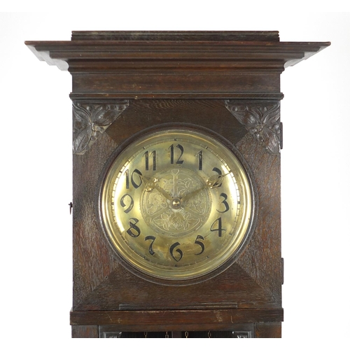 7 - Arts & Crafts carved oak eight day long case clock striking on a gong, the brass face with Arabic nu... 