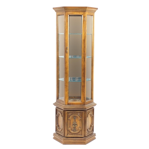 2052A - American walnut display cabinet a central door enclosing three shelves and mirrored back, above a cu... 
