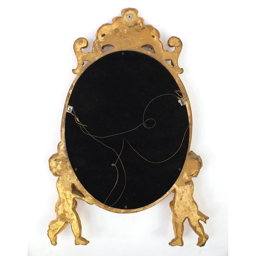 2010 - Ornate gilt putti design mirror with oval aperture, 66cm  x 44.5cm