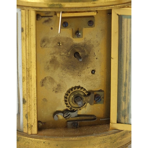2094 - Gilt brass oval carriage clock with enamelled dial and Arabic numerals, 11.5cm