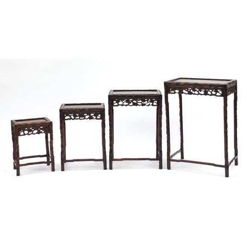 2005 - Chinese rosewood quartetto nest of occasional tables carved with flowers, the largest 72cm H x 50.5c... 